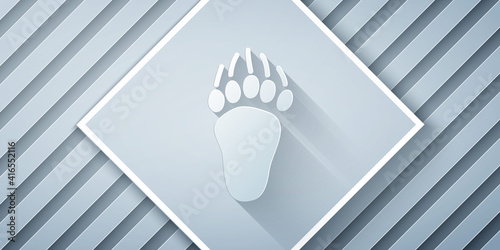 Paper cut Bear paw footprint icon isolated on grey background. Paper art style. Vector.