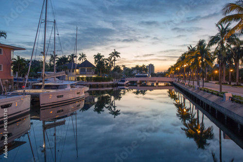View along tranquil canal at dawn, yachts reflected in still water, Nurmi Isles, Fort Lauderdale, Florida, United States of America, North America photo