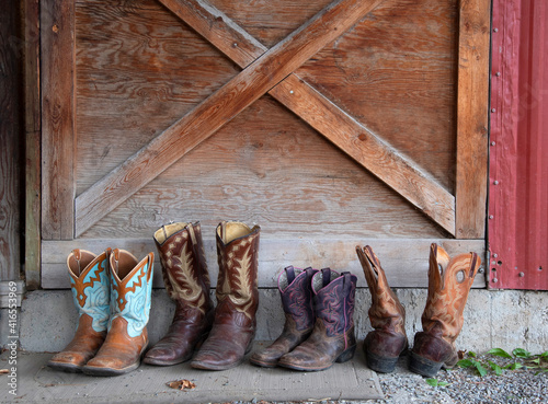 Cowboy boots lined up at a stable, Merritt, British Columbia, Canada, North America photo