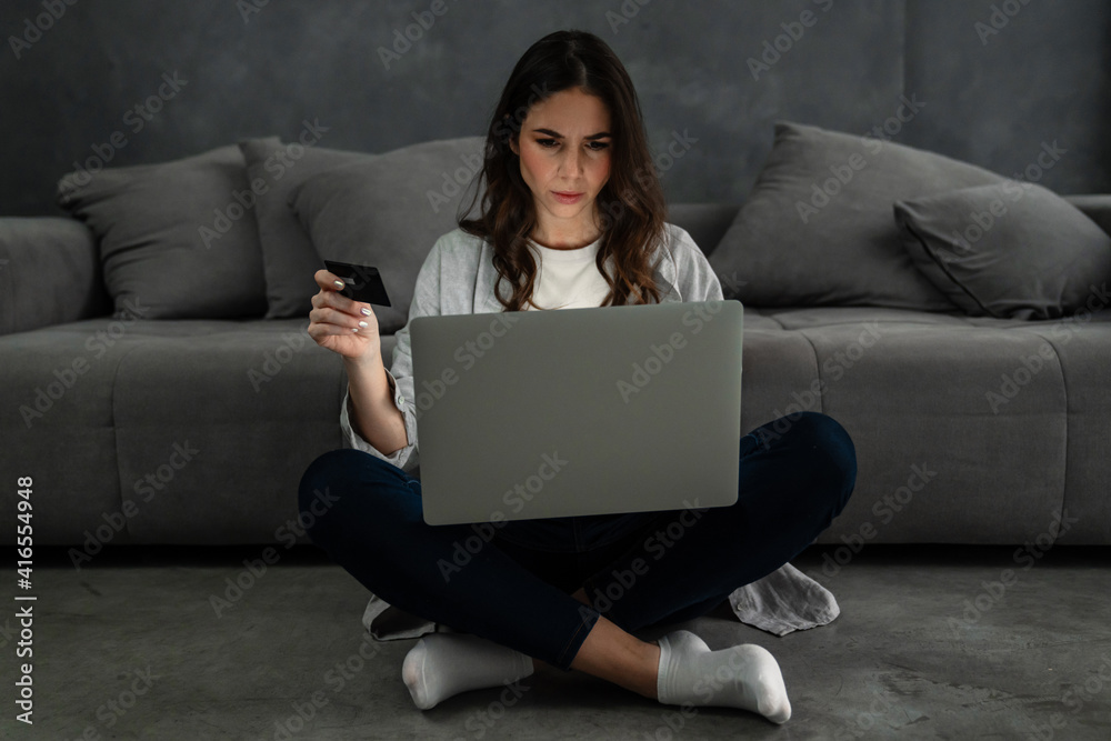 Upset confused woman sitting on couch Upset confused woman sitting on couch