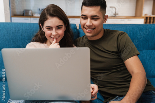 Smiling happy couple on a video call via laptop computer © Drobot Dean
