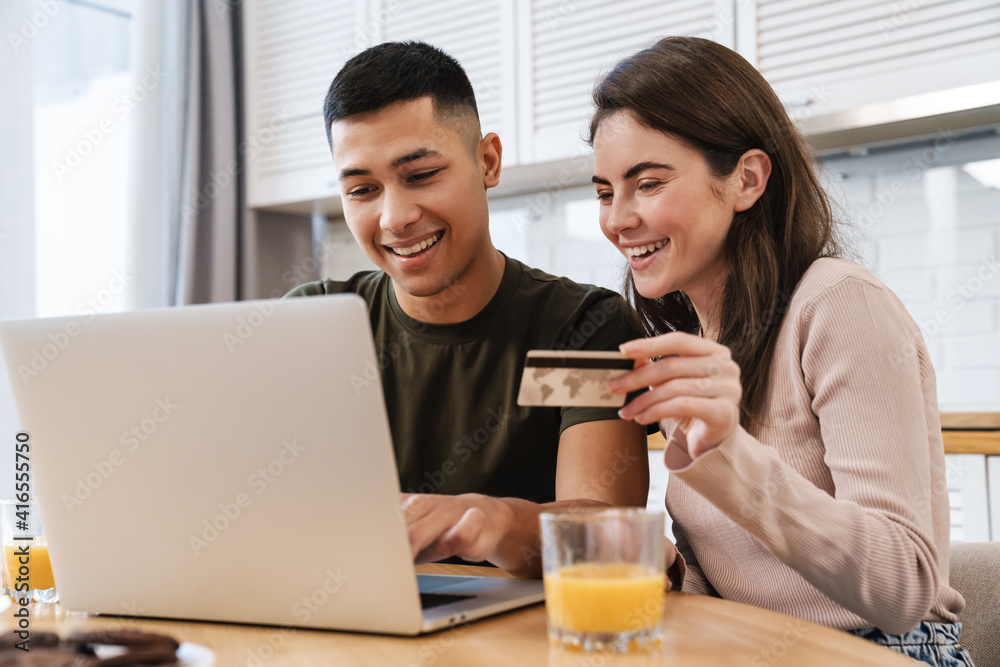 Portrait of a cheerful couple shopping online Portrait of a cheerful couple shopping online