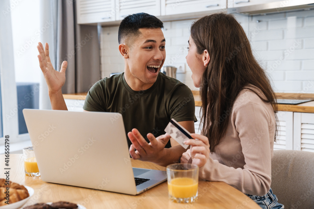 Portrait of a cheerful couple shopping online Portrait of a cheerful couple shopping online