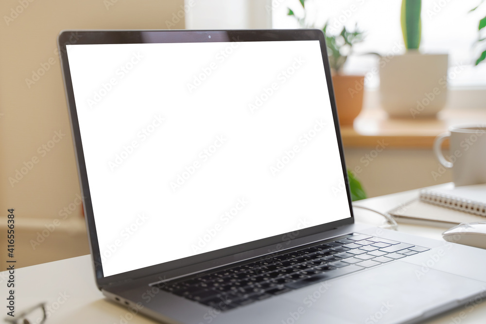 An open laptop with a white screen as a place for text. Office concept An open laptop with a white screen as a place for text. Office concept