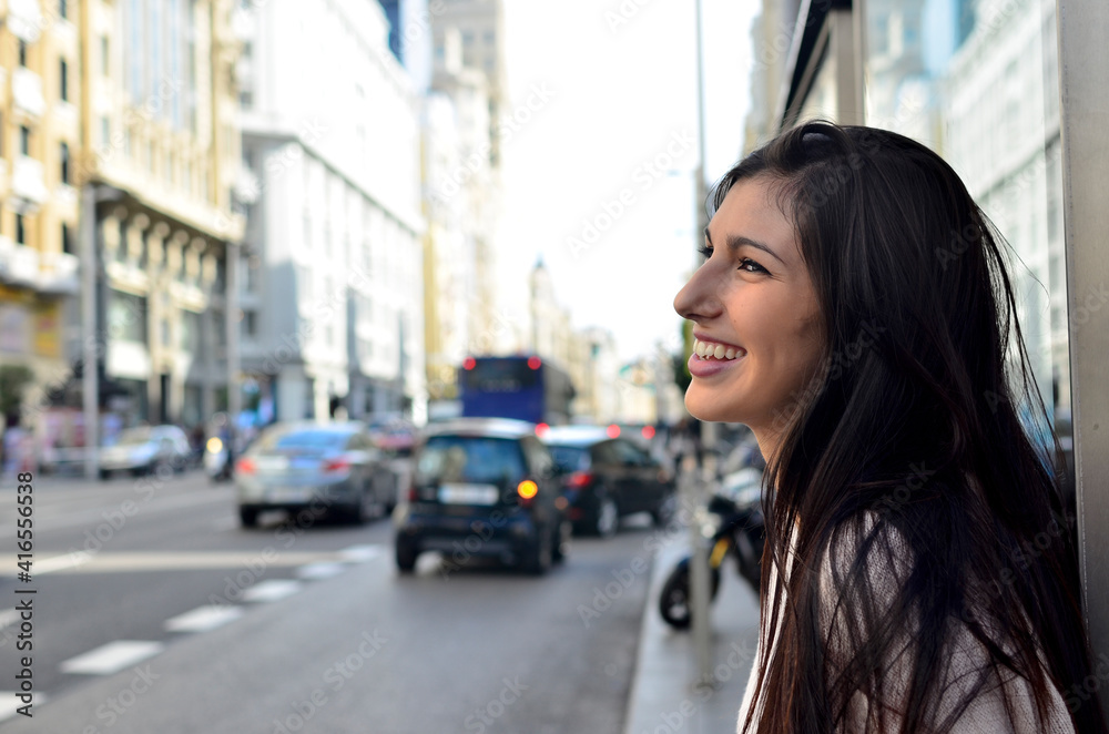 Pretty Woman with radiant smile in the city