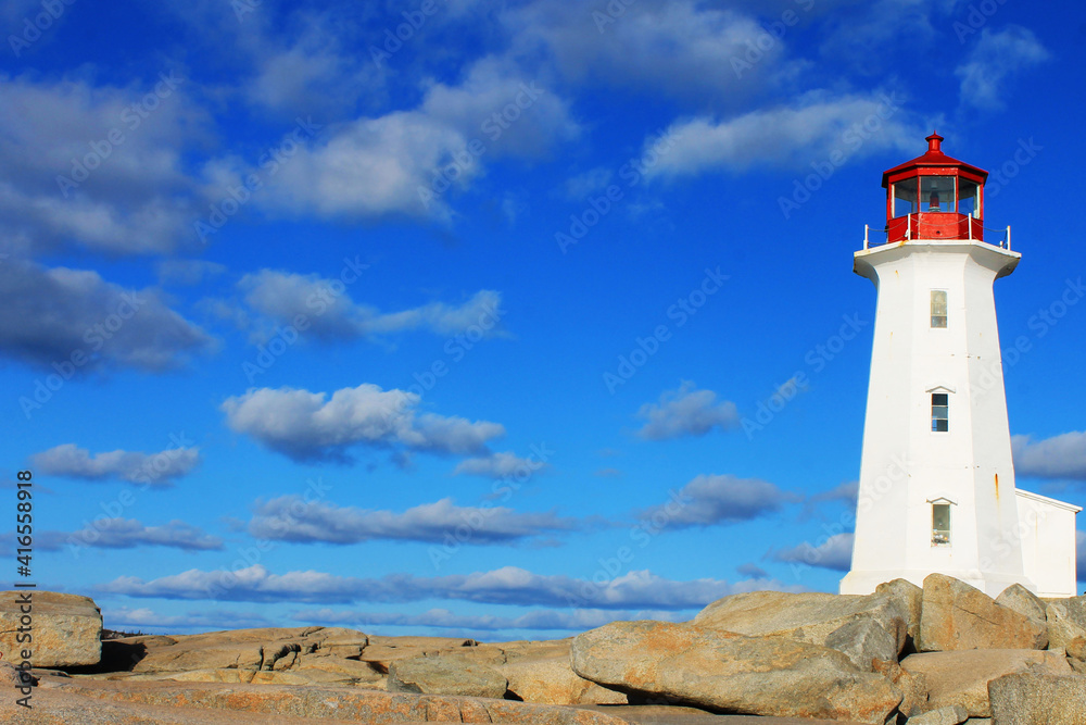 Light house at Peggy's Cove, Nova Scotia. Sunny, autumn day, lots of blue sky with light cloud. Lots of copy space.