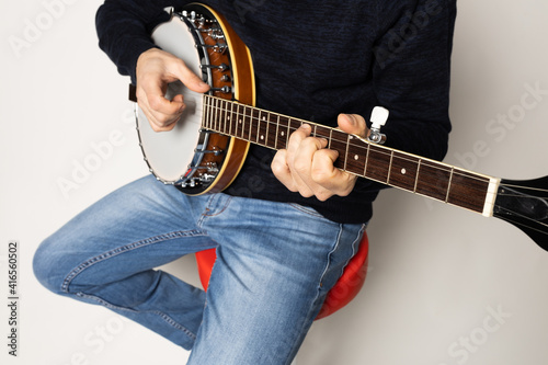 Photography young man playing banjo on the white background