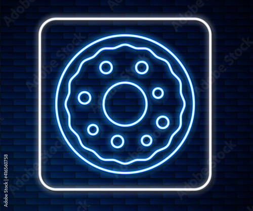 Glowing neon line Donut with sweet glaze icon isolated on brick wall background. Vector.