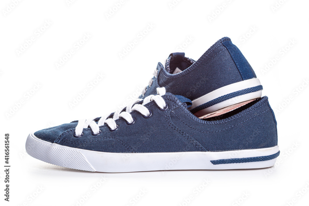 blue sneakers on white background with copy space. Youth shoes. blue sneakers on white background with copy space. Youth shoes.