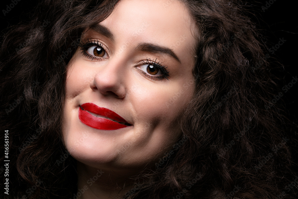 Portrait of a beautiful brunette girl with curly hair and red lipstick. Portrait of a beautiful brunette girl with curly hair and red lipstick.