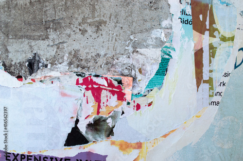 glued paper, remains, torn on the wall,concrete