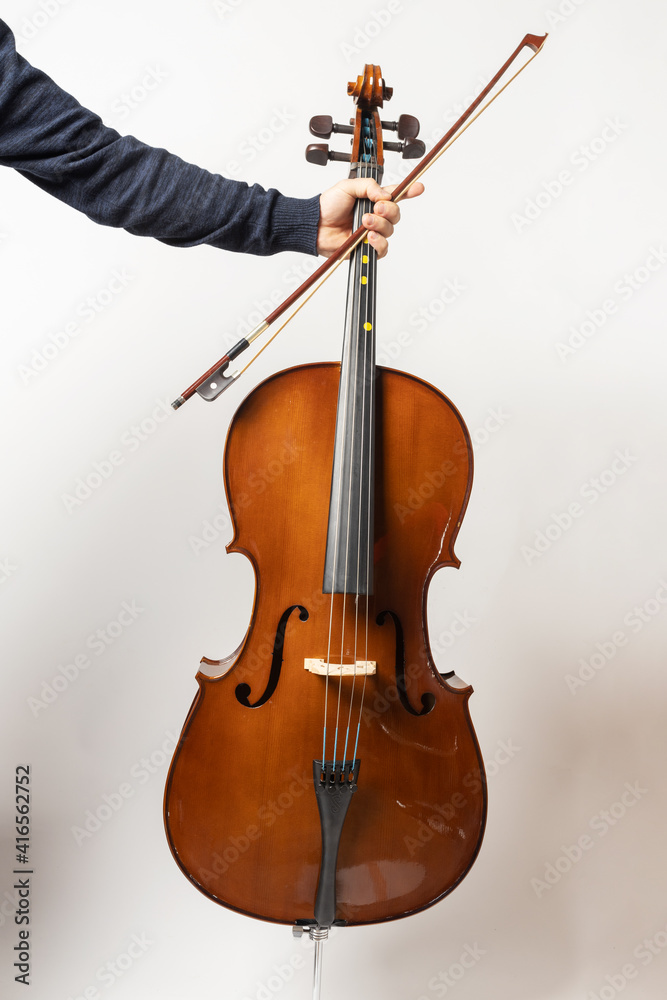 Fototapeta premium young man playing cello on the white background