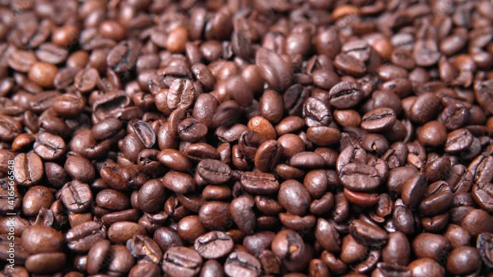 Coffee beans background. Falling coffee beans close up. selective focus Coffee beans background. Falling coffee beans close up. selective focus