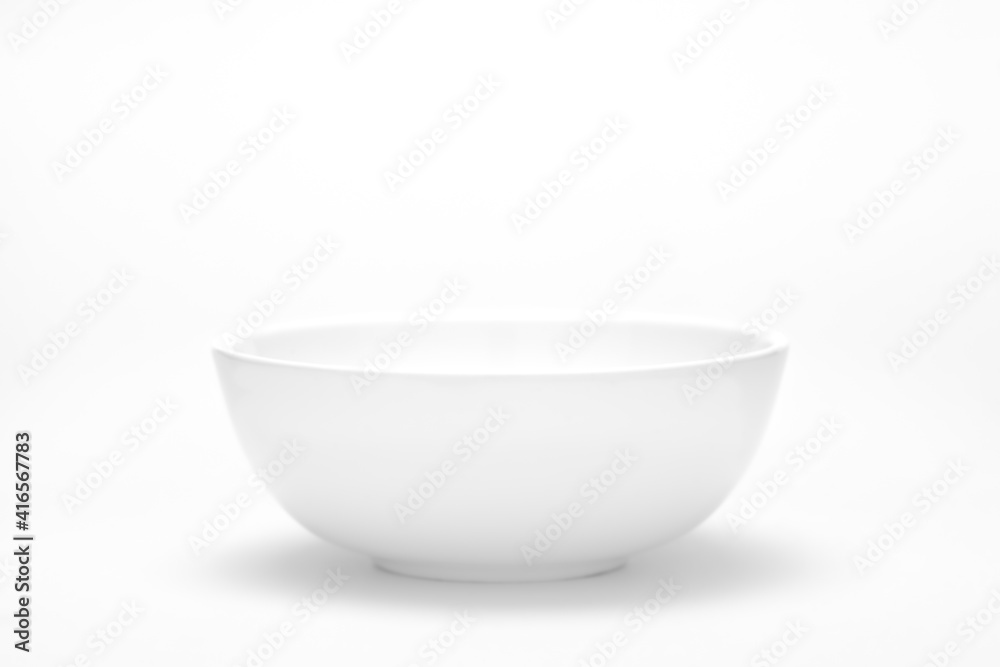 An empty white ceramic white bowl for mockup. Top lighting. An empty white ceramic white bowl for mockup. Top lighting.