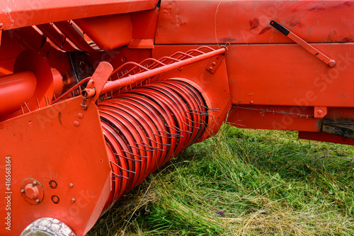 Tableau sur toile Hay baler close up, rake press and constructing details.