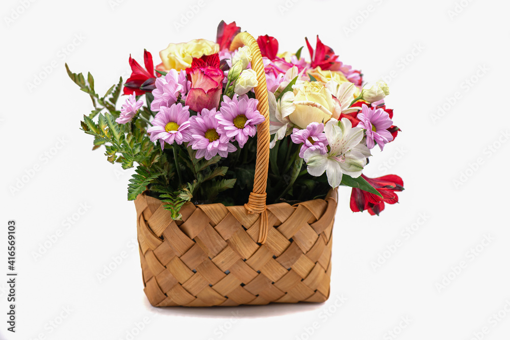 Bouquet of flowers in a basket on a white background