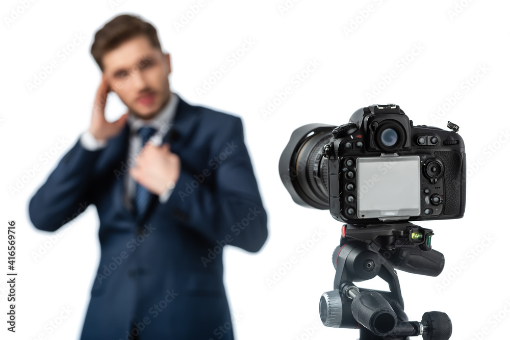 selective focus of digital camera near news anchor on blurred foreground isolated on white