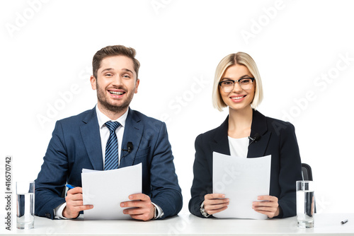 news presenters smiling at camera while holding papers at workplace isolated on white photo