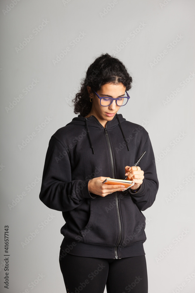 Young person taking notes Young person taking notes