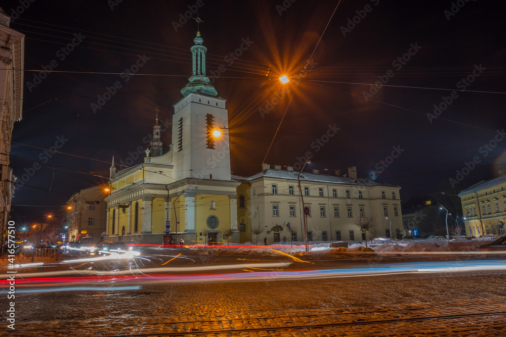 Obraz premium Night Lviv old city architecture in the winter season. Buildings highlighted by the illumination