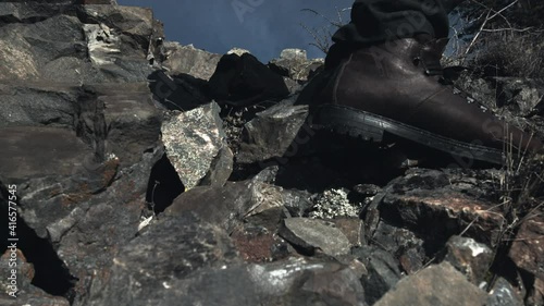 A traveler stepping down the stone path in boots photo