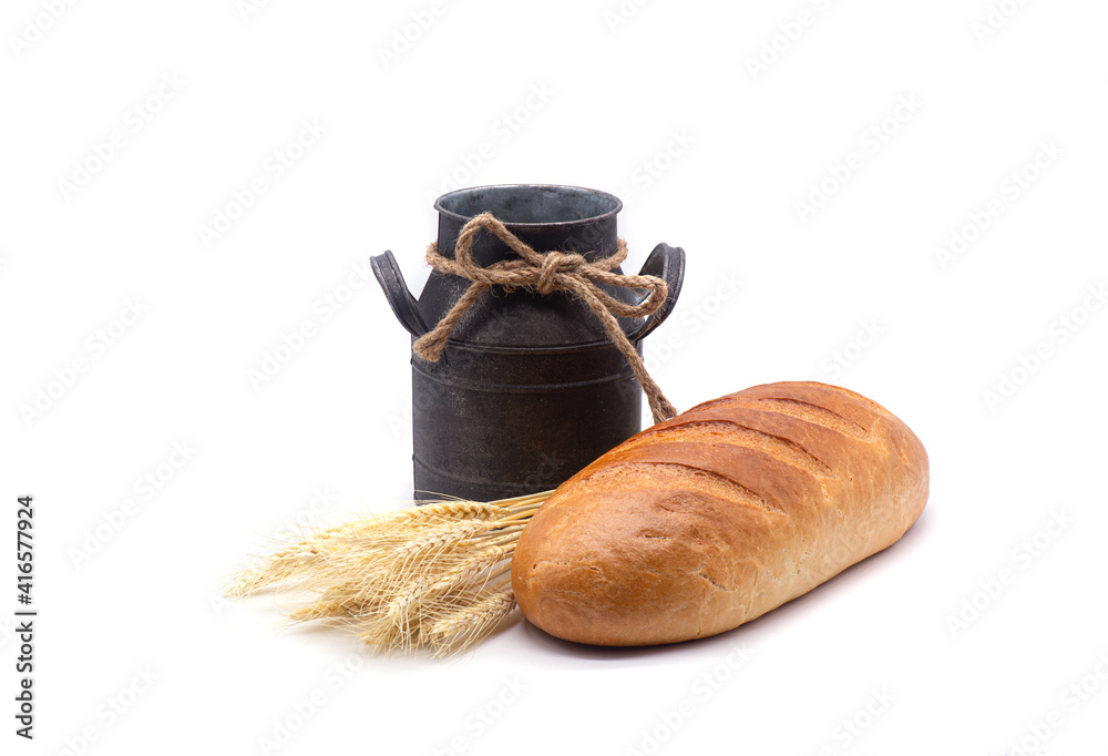 Composition of white bread, wheat, an old jug on white background