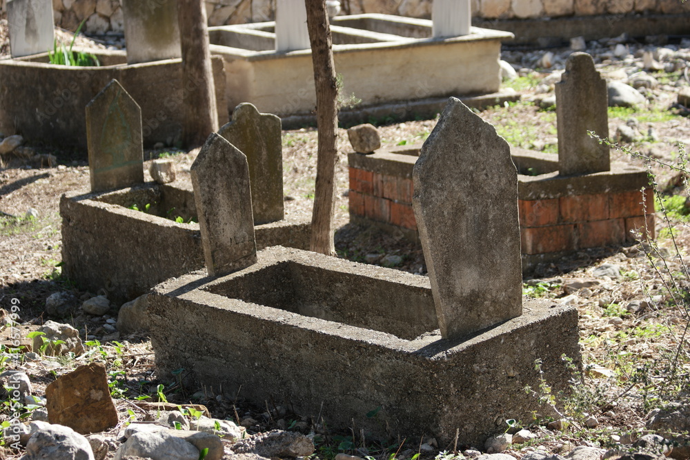 Islamic old gravestones in a cemetery. Muslim turkish graveyard