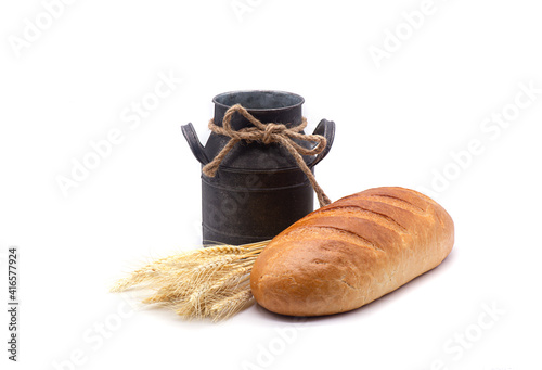 Obraz na płótnie Composition of white bread, wheat, an old jug on white background w salonie