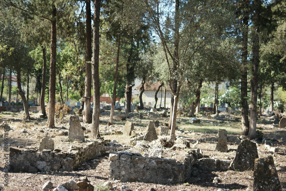 Old Muslim cemetery background. Graves and tombstones in ancient