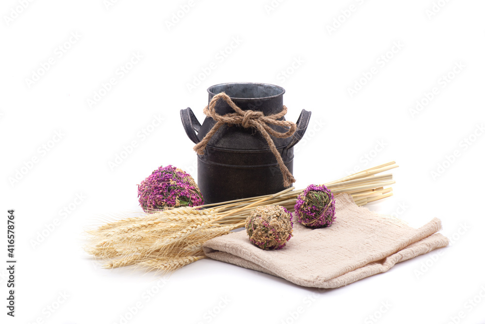 Composition of wheat, antique jug, kitchen towel and dried flowers on white background