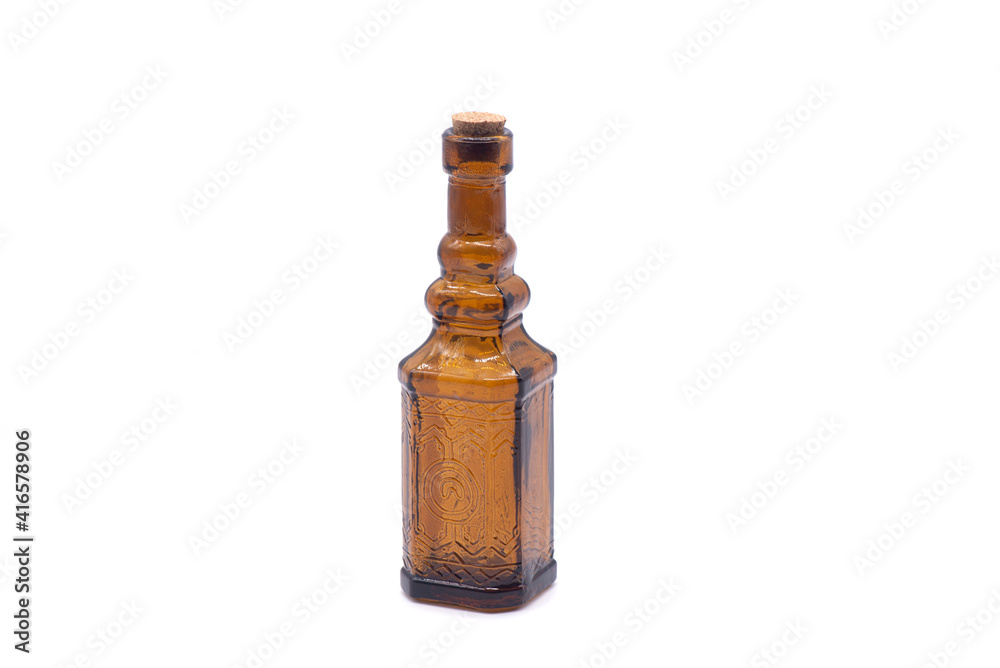 Small empty brown glass bottle on white background