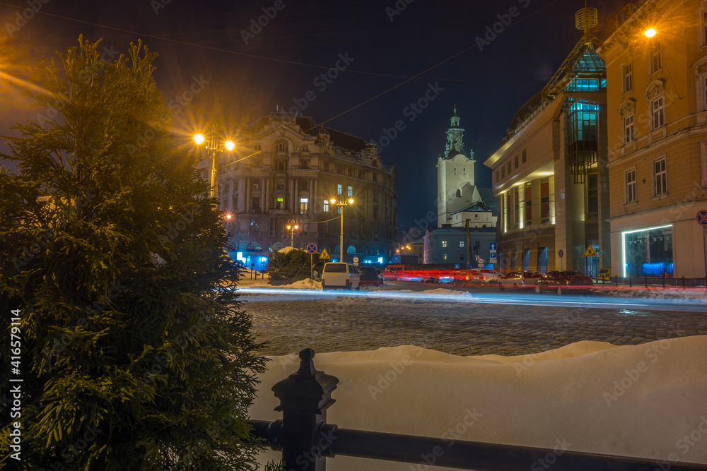 Naklejka premium Night Lviv old city architecture in the winter season. Buildings highlighted by the illumination