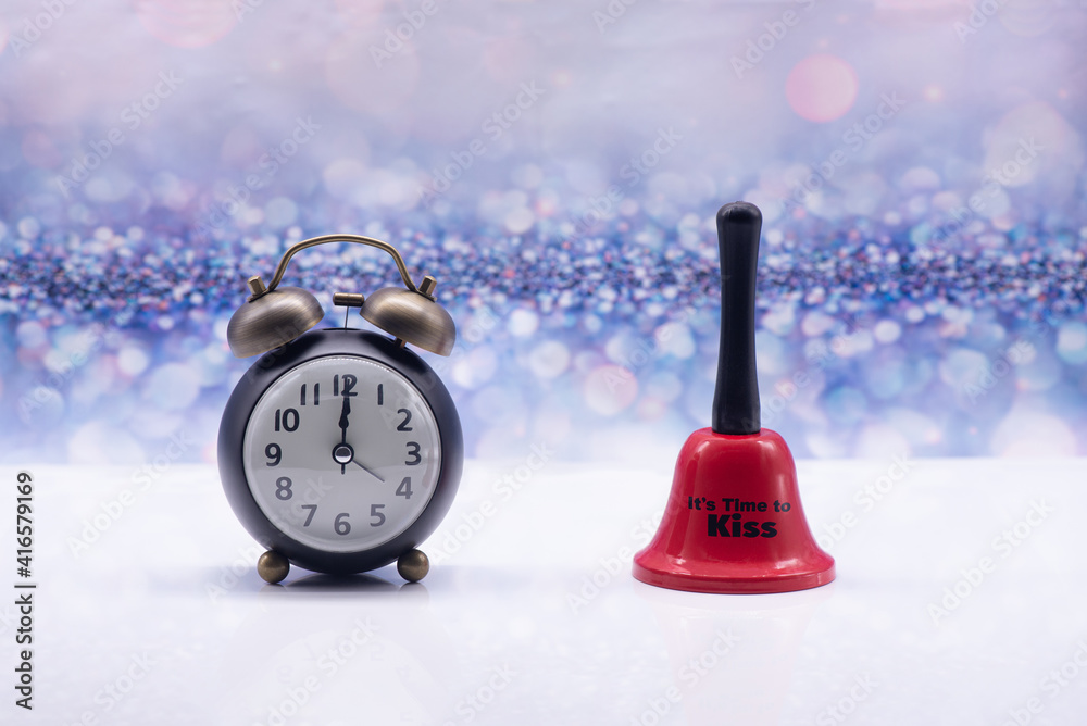 Retro alarm clock and red bell with inscription It's time to kiss on a festive background