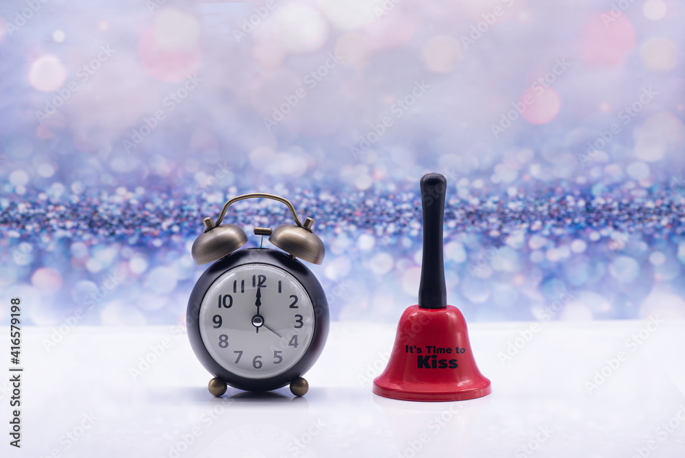 Retro alarm clock and red bell with inscription It's time to kiss on a festive background