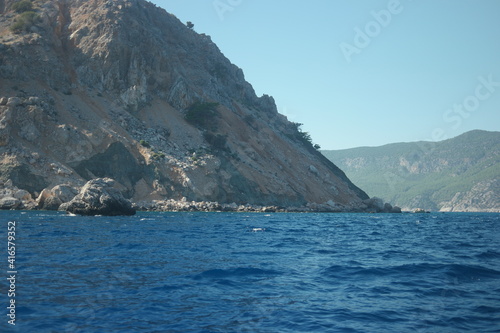 Summer seascape with mountains and blue sea water. Rocky island and the sea.