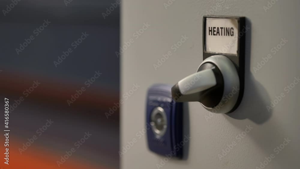 Closeup Of A Hand Turning A Industrial Heating Switch In A Factory, Industrial Heater