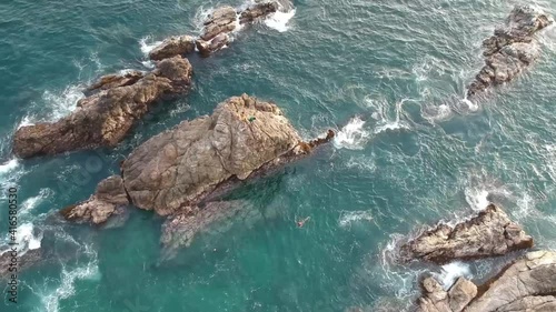 Aerial shot of San Agustinillo beach, Oaxaca, Mexico, wide shot directly above pan left photo