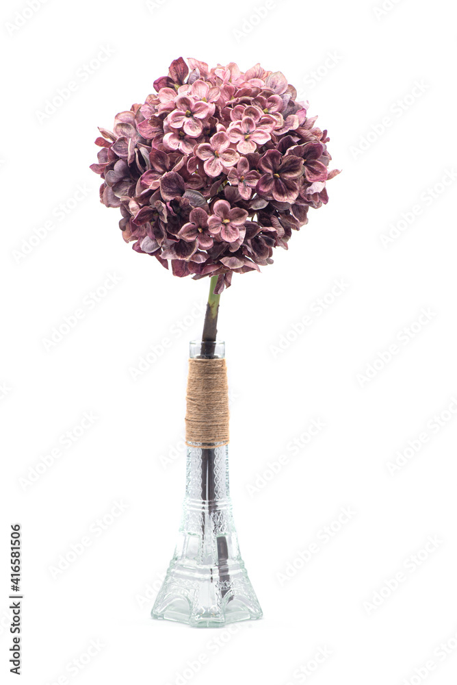Artificial flowers in a glass vase on a white background