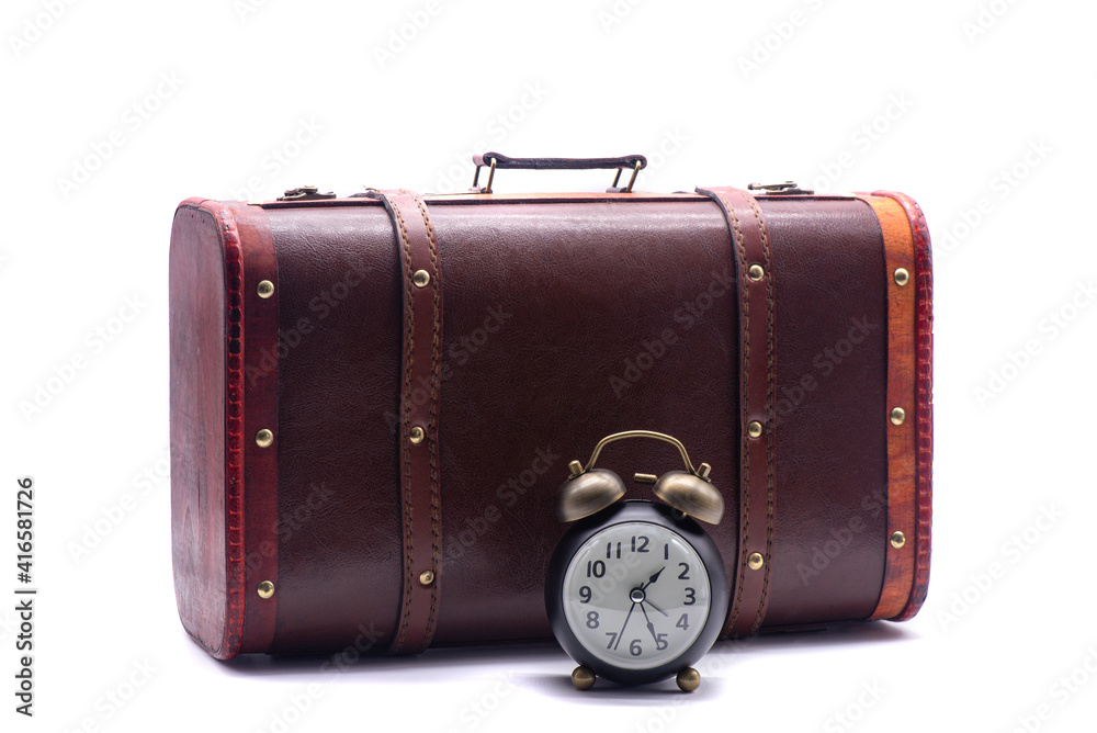 Retro suitcase and retro alarm clock on white background