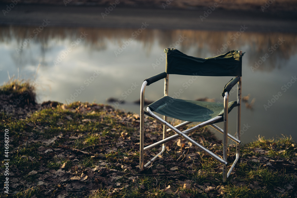 Folding Chair and Fishing Rod on Lake Stock Photo - Image of folding,  deckchairs: 145694556