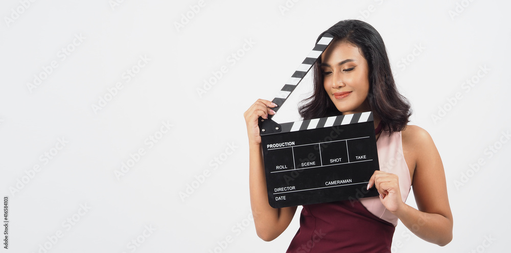Asian woman hold black clapper board or movie slate isolated on white background.She have tan skin ,show film,movies or cinema production concept. 