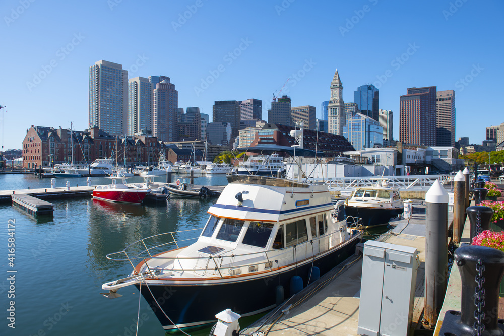 Yachts at Lewis Wharf in Boston Harbor with Boston skyline and Custom House, city center of Boston, Massachusetts MA, USA. 