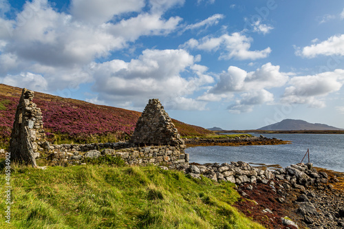 A View from the Bank of Loch Langass on the Hebridean Island of North Uist, with Heather on the Hills and Ruins in the Foreground photo