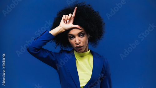 Fényképezés African american woman showing loser sign isolated on blue