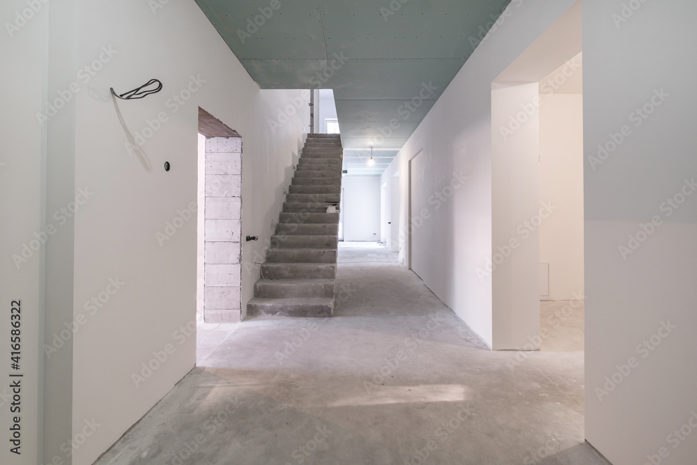 Obraz premium empty white room with concrete stair without repair and furniture