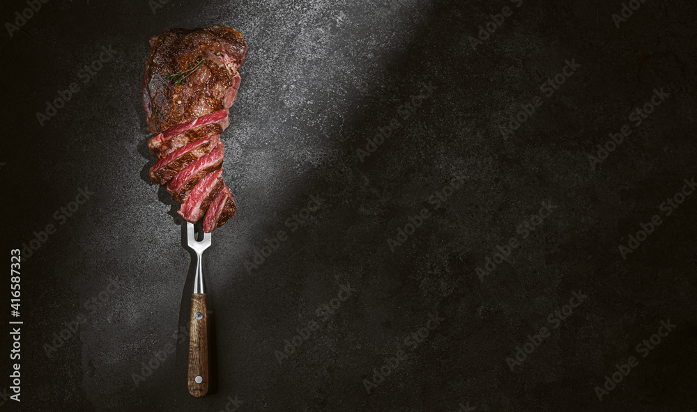 barbeque steak on a black slate board