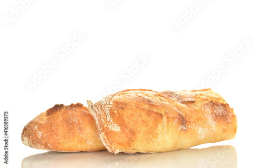 Two delicious freshly baked French baguette halves, close-up, isolated on white.