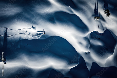 A mand and woman are powder skiing in British Columbia, Canada.