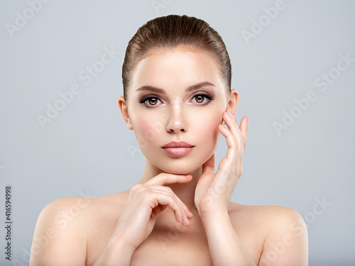 Front portrait of a white young woman with beauty face - isolated. Skin care concept.