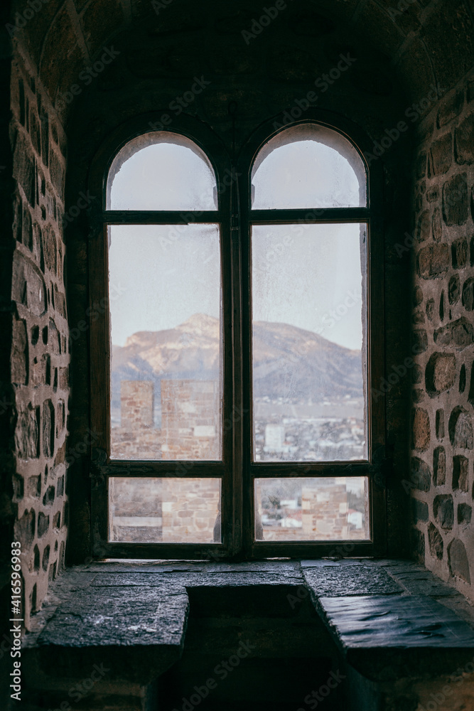 Obraz premium Old castle window overlooking the fortress, middle ages